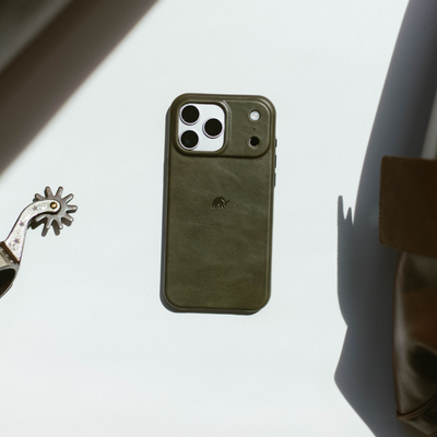 Olive green leather phone case with triple-camera cutout and small embossed elephant logo