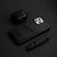 A black minimalist portfolio case with card slot, an AirPods case, and a knife on a dark surface.